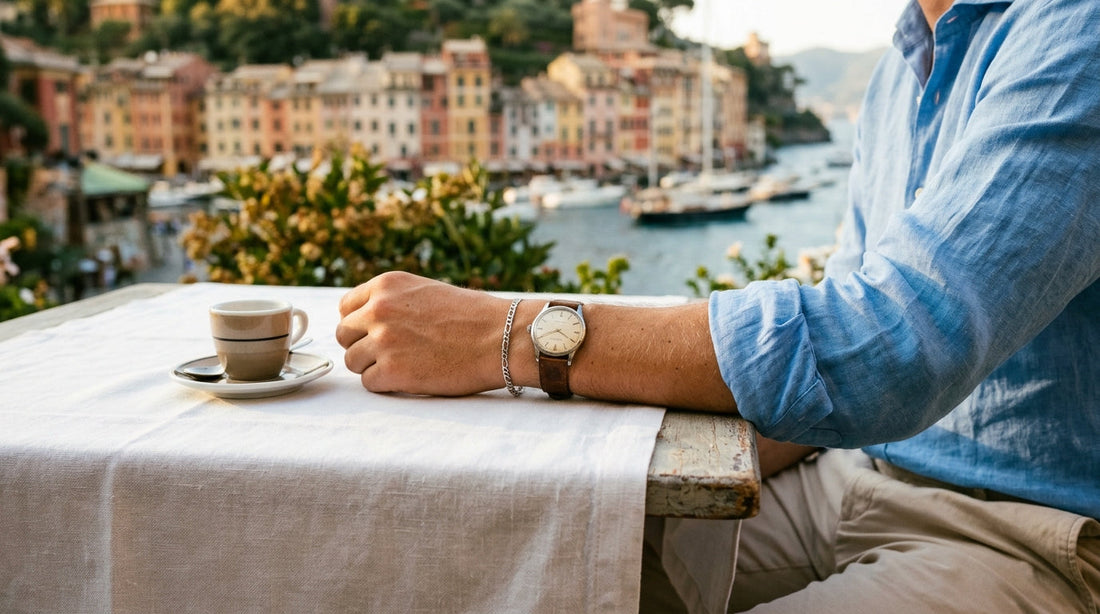 4mm steel figaro chain bracelet worn with a watch on a cafe table