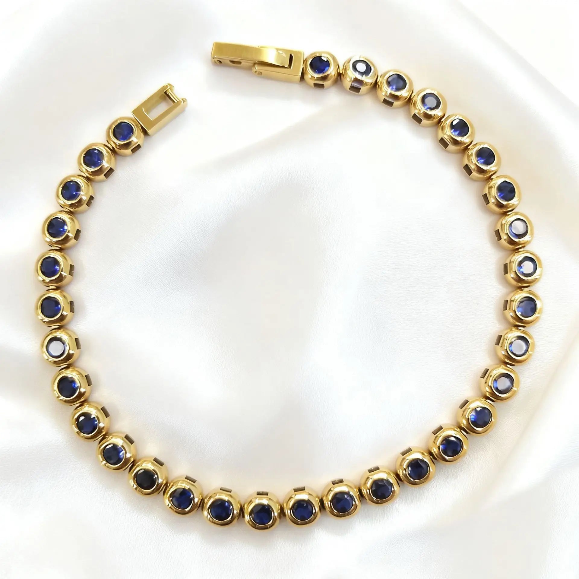 Gold with Dark Blue Zircon