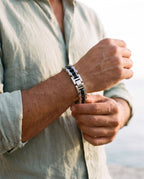 Man adjusting the Marco Maveri Bicycle Chain Link Bracelet, close-up, Black / Silver