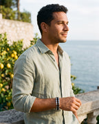 Man wearing the Marco Maveri Bicycle Chain Link Bracelet by the sea, Black / Silver