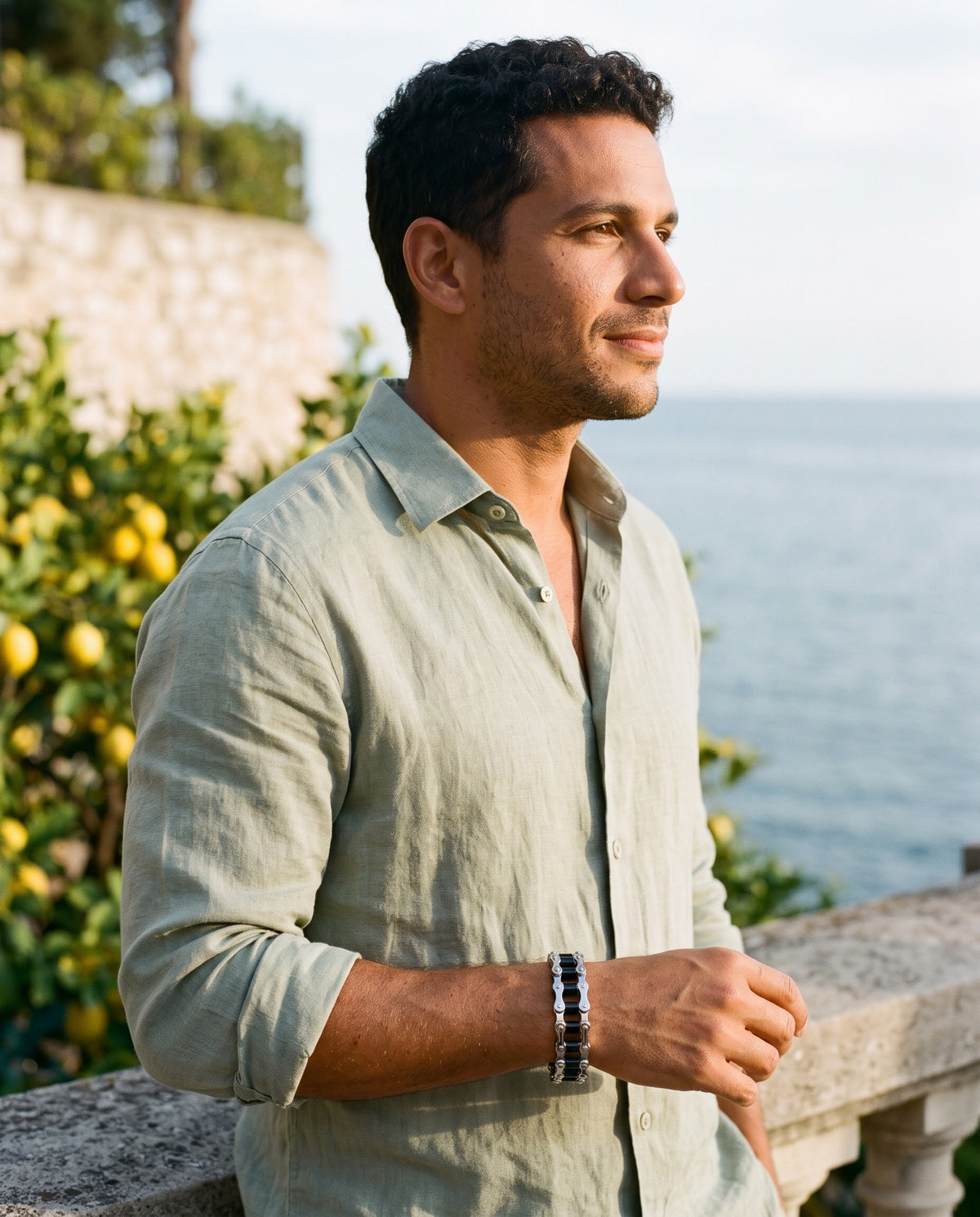 Man wearing the Marco Maveri Bicycle Chain Link Bracelet by the sea, Black / Silver