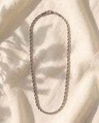 Marco Maveri Braided Titanium Steel Chain laid on cream linen, Silver