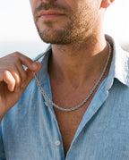 Man adjusting the Marco Maveri Braided Titanium Steel Chain, close-up, Silver