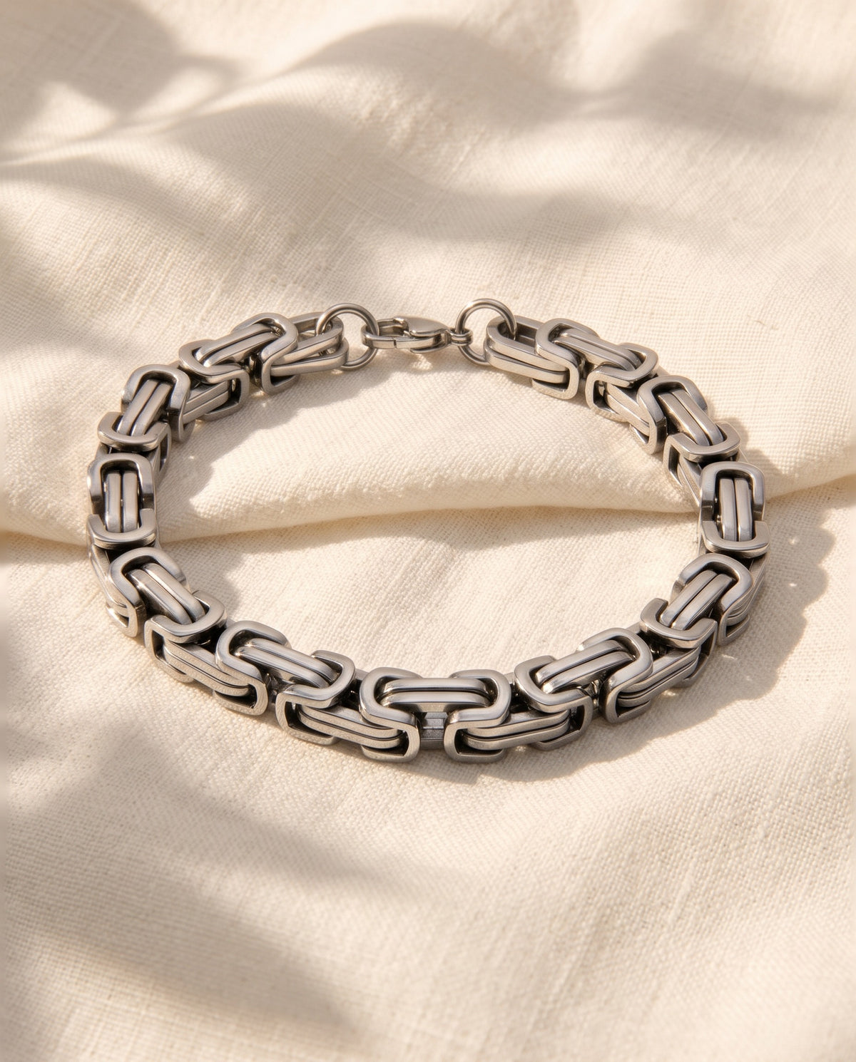 Marco Maveri Byzantine Link Bracelet laid on cream linen, Silver