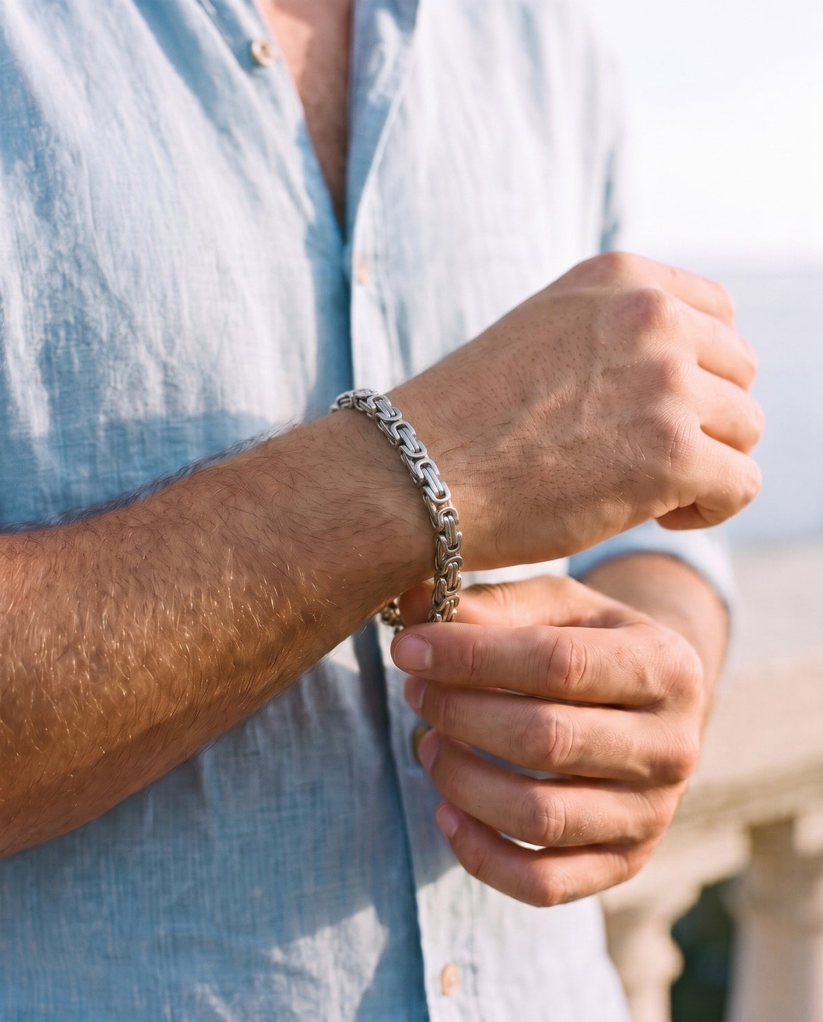 Man adjusting the Marco Maveri Byzantine Link Bracelet, close-up, Silver