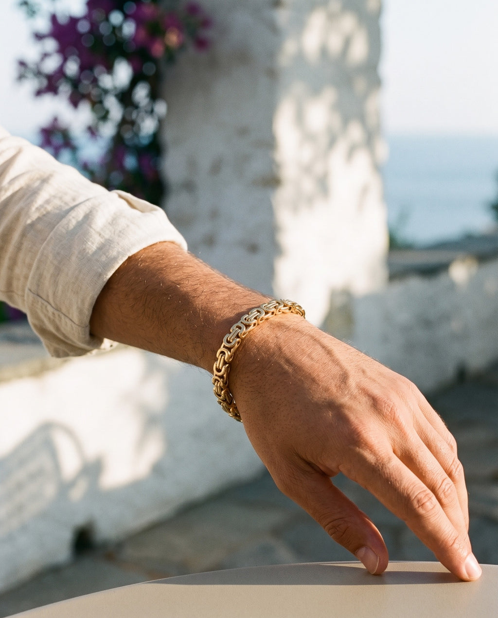 Marco Maveri Byzantine Link Chain Bracelet worn with a linen shirt, close-up, Gold