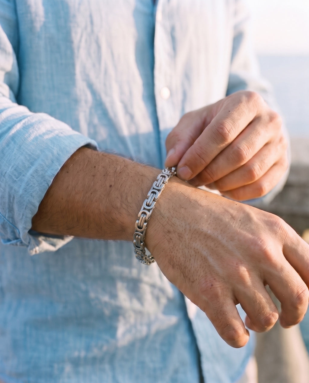 Man adjusting the Marco Maveri Byzantine Link Chain Bracelet, close-up, Silver