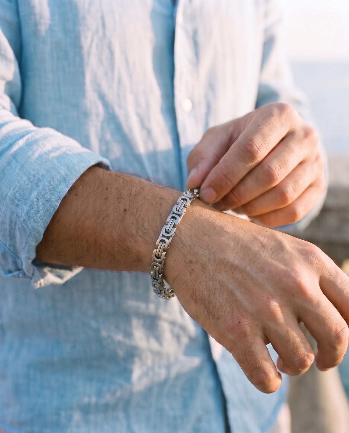 Man adjusting the Marco Maveri Byzantine Link Chain Bracelet, close-up, Silver