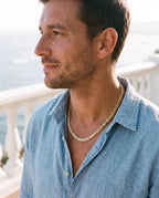 Man wearing the Marco Maveri Byzantine Link Chain Necklace by the sea, Gold
