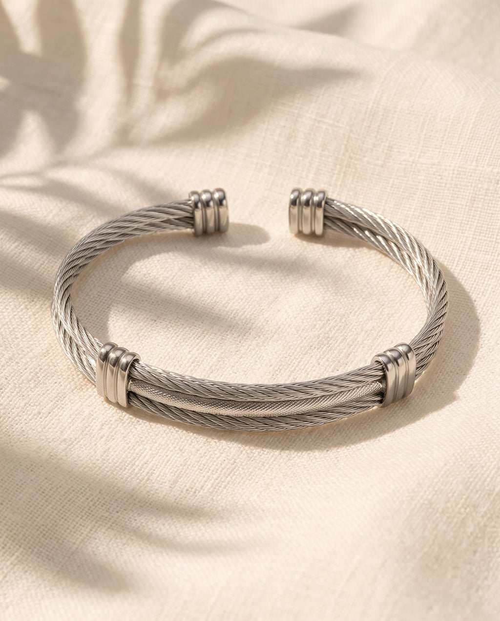 Marco Maveri Cable Cuff Bracelet laid on cream linen, Silver