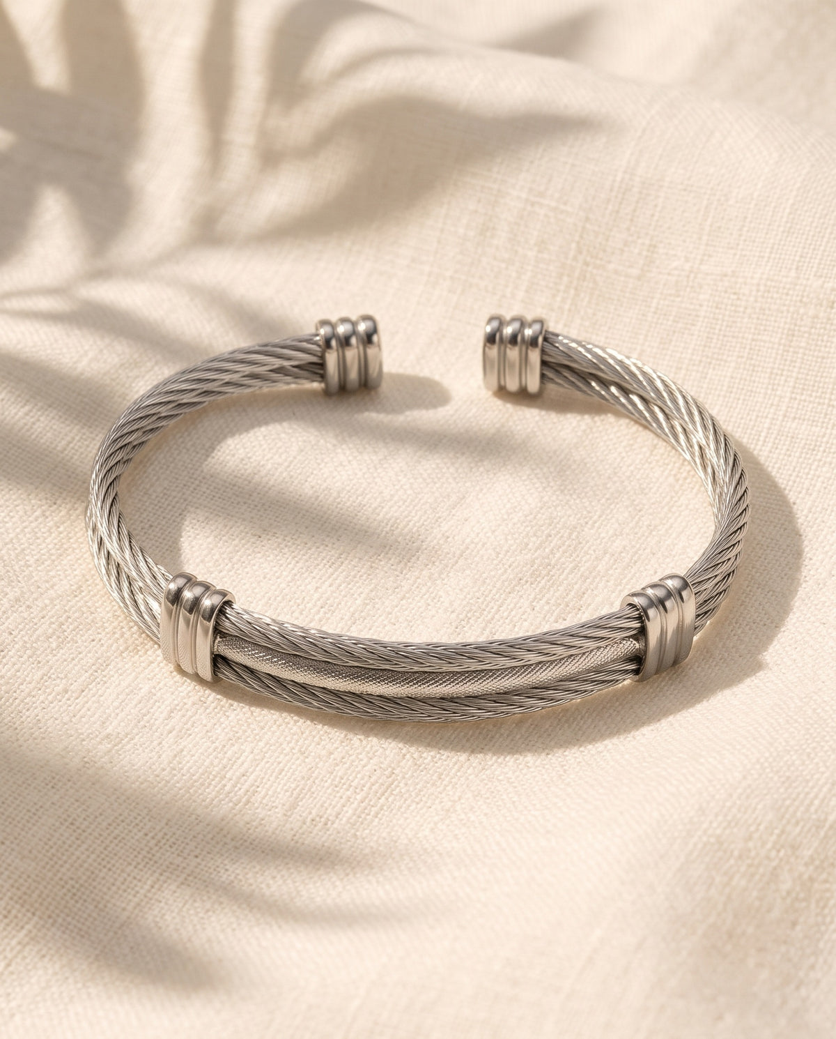 Marco Maveri Cable Cuff Bracelet laid on cream linen, Silver