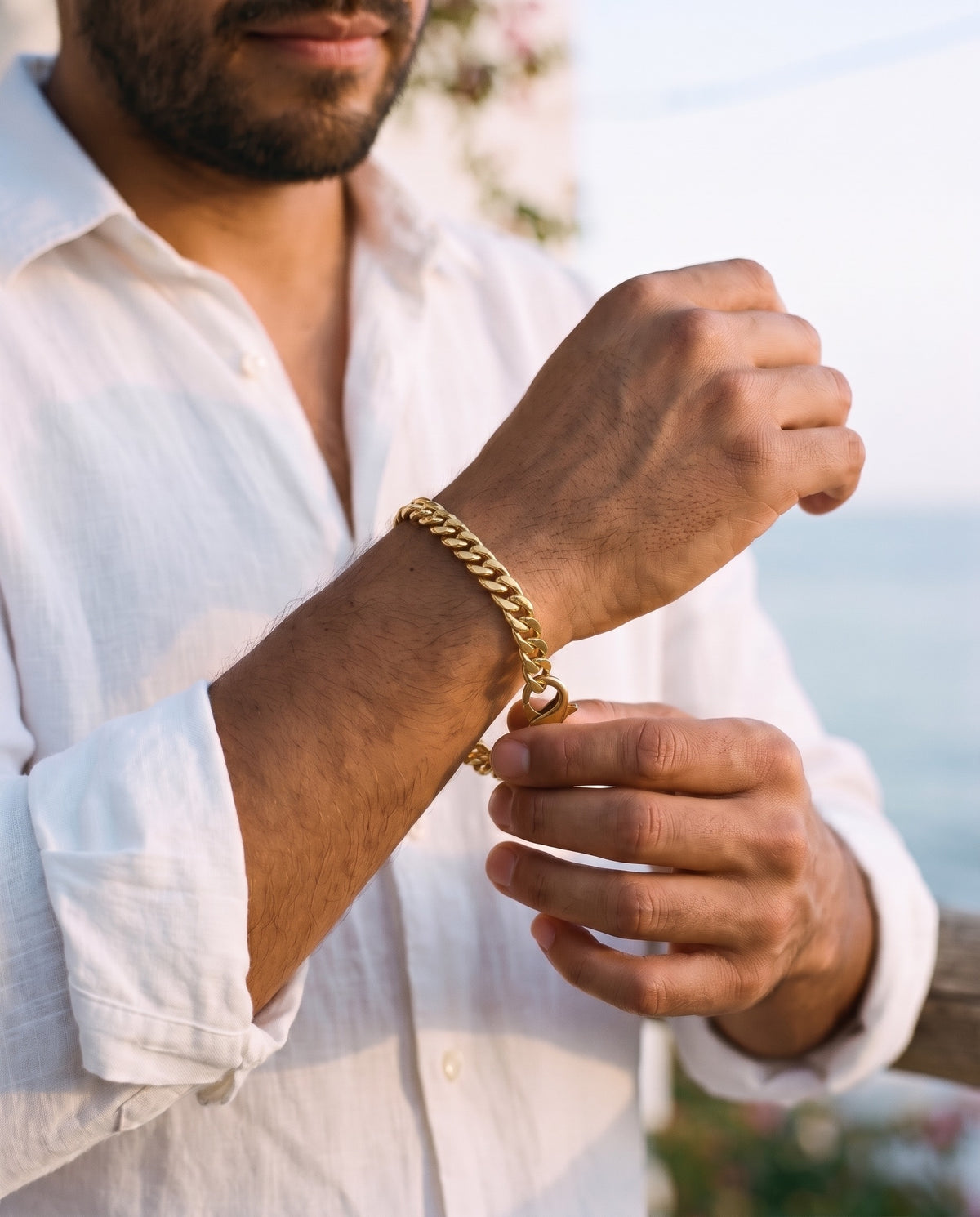 Man adjusting the Marco Maveri Chunky Curb Link Bracelet, close-up, Gold