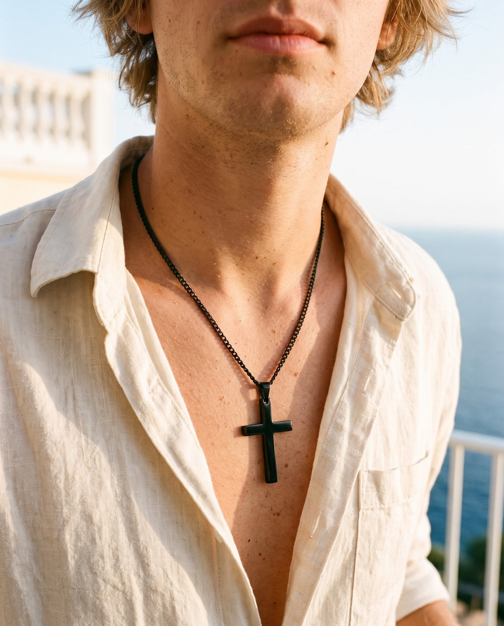 Marco Maveri Classic Cross Pendant Necklace worn with a linen shirt, close-up, Black