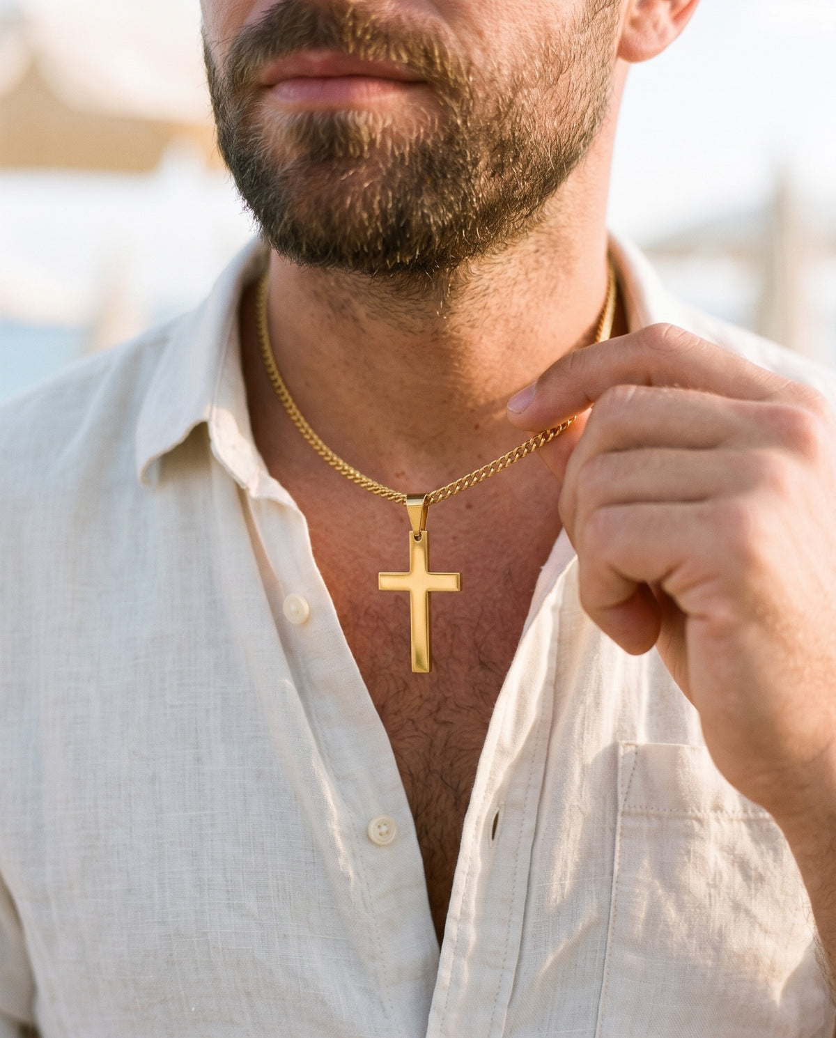 Man adjusting the Marco Maveri Classic Cross Pendant Necklace, close-up, Gold