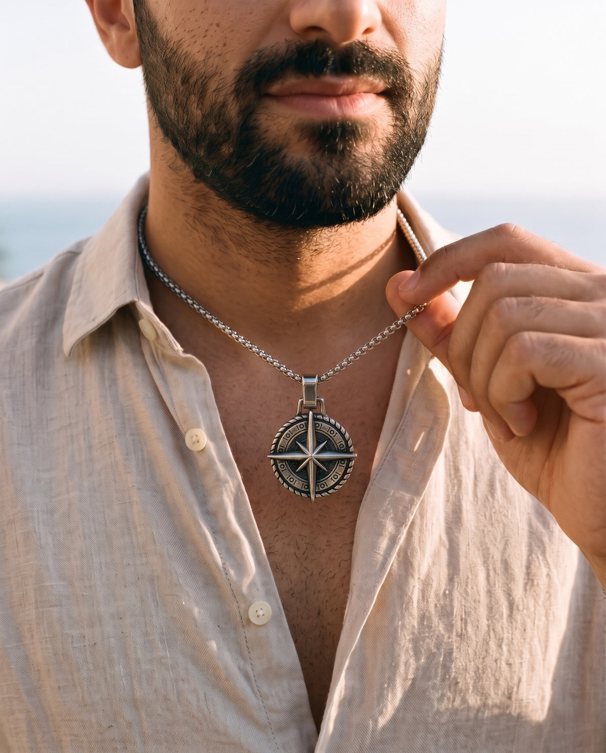 Man adjusting the Marco Maveri Compass Pendant Necklace, close-up, Silver