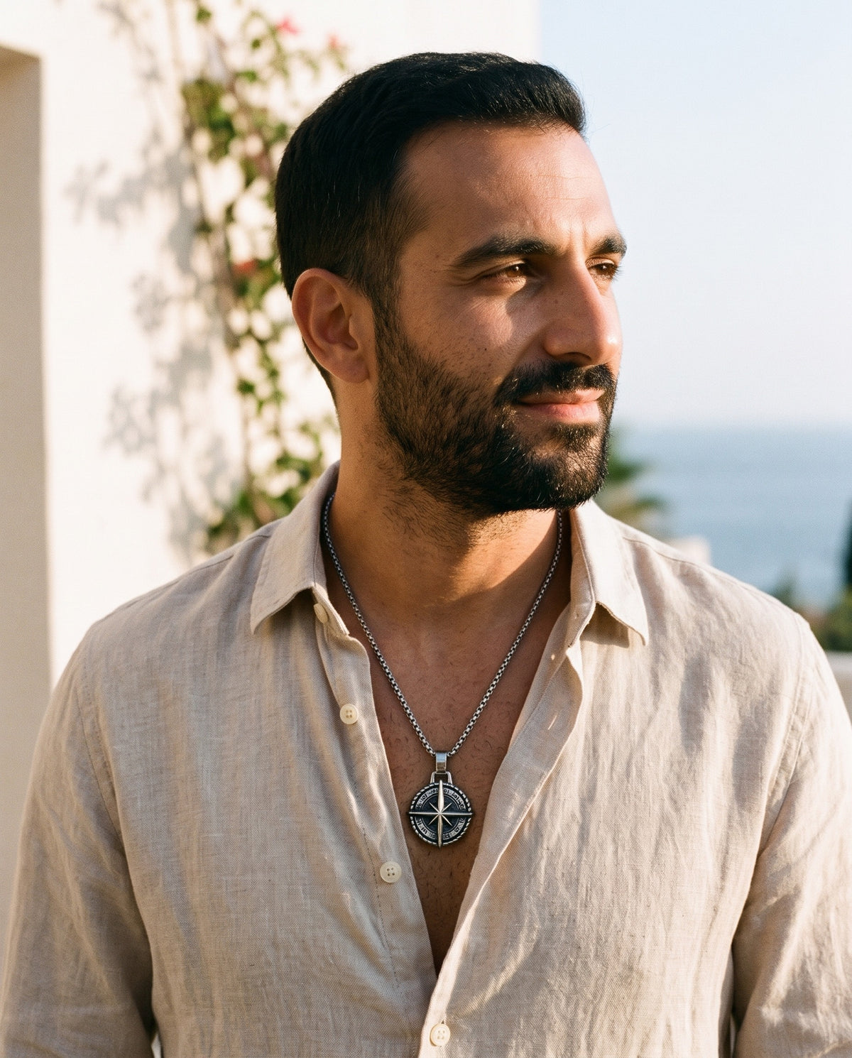 Man wearing the Marco Maveri Compass Pendant Necklace by the sea, Silver