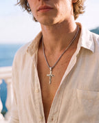 Marco Maveri Crucifix Pendant Necklace in Titanium Steel worn with a linen shirt, close-up, Silver