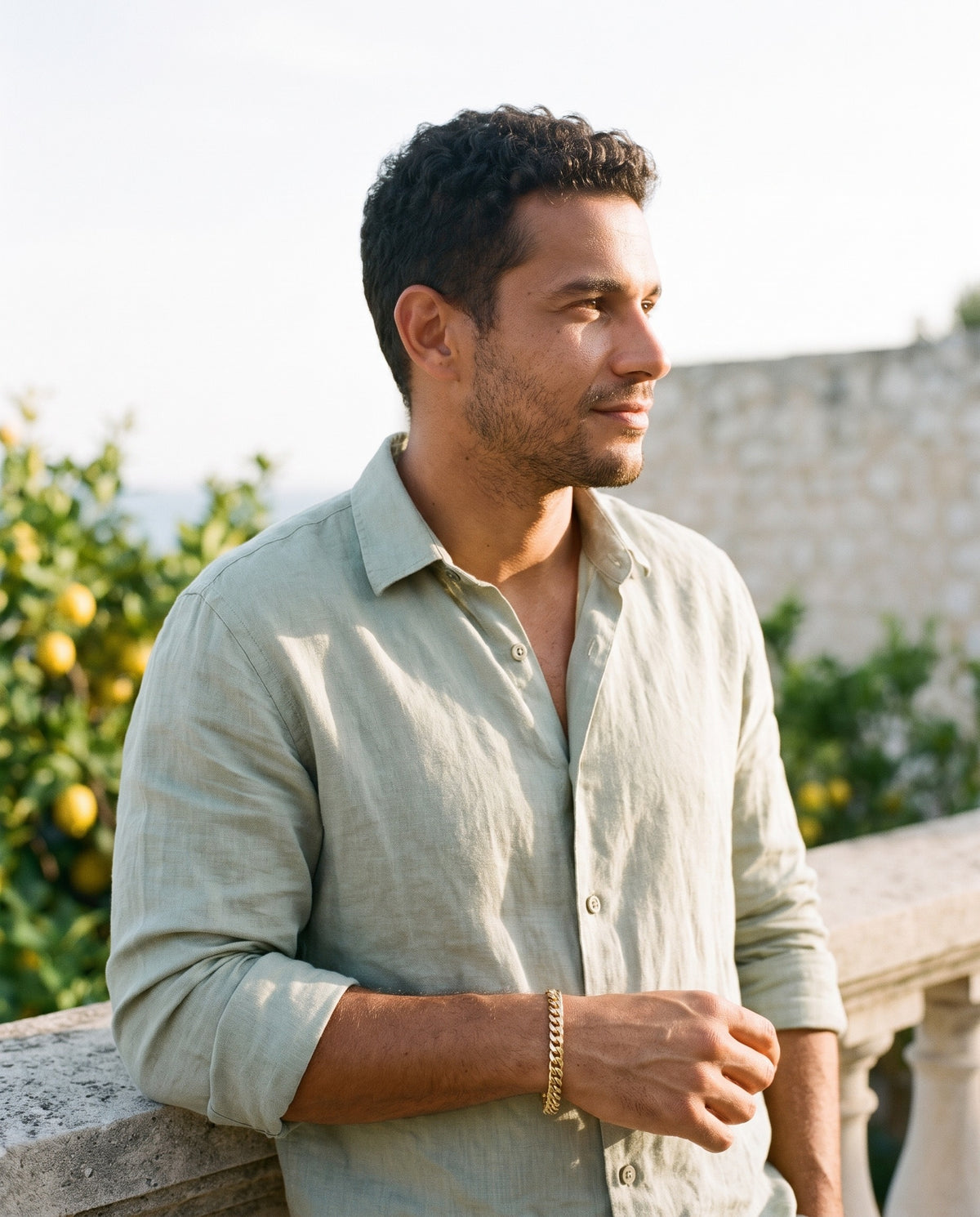 Man wearing the Marco Maveri Cuban Link Bracelet in Stainless Steel by the sea, Gold