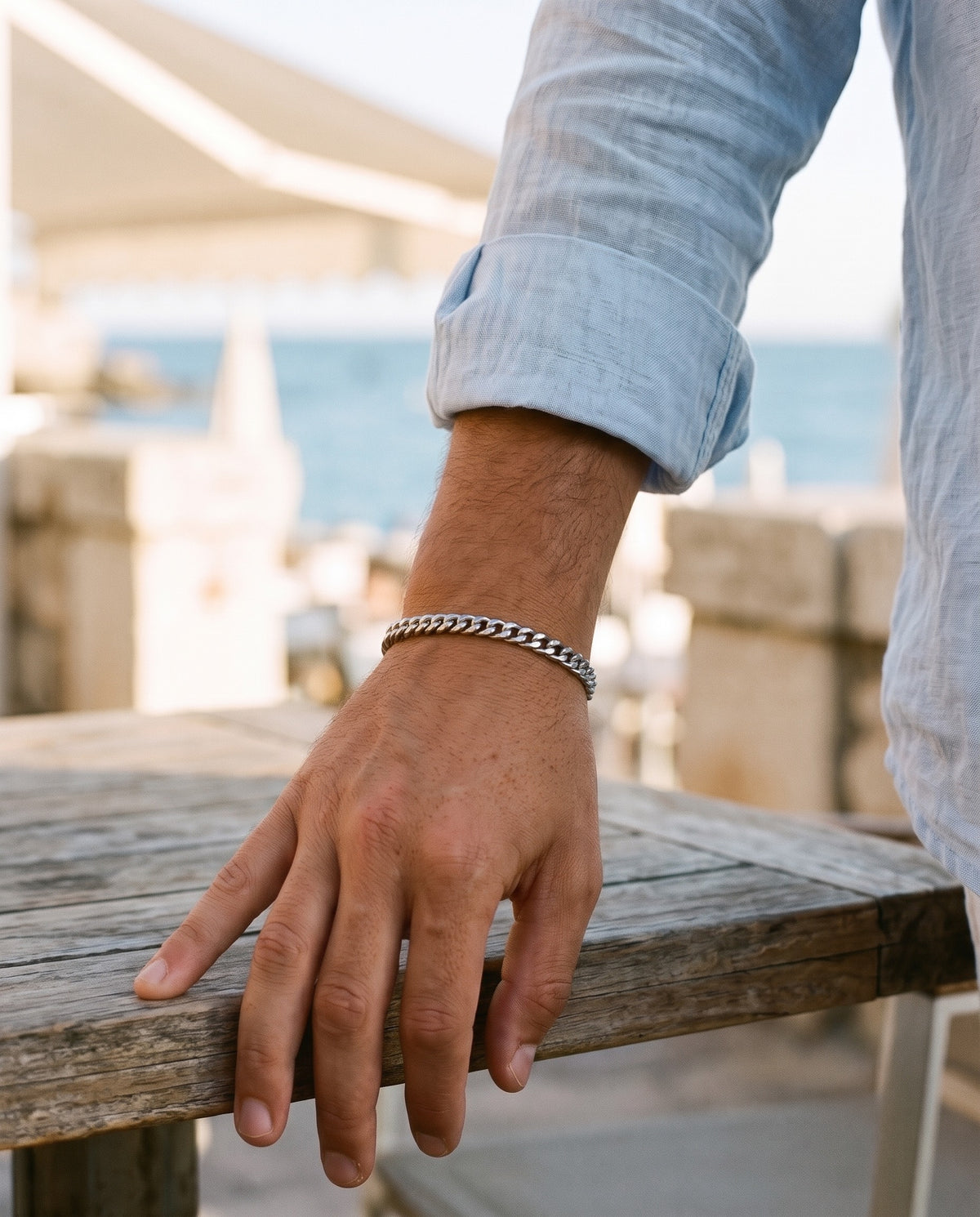 Marco Maveri Cuban Link Bracelet in Stainless Steel worn with a linen shirt, close-up, Silver