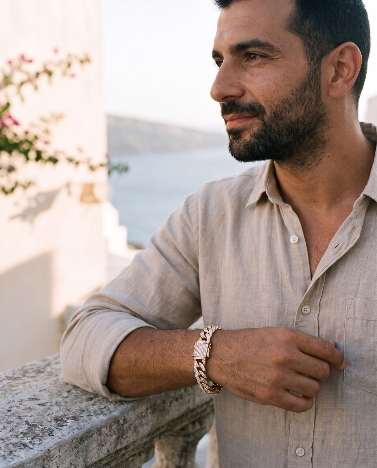 Man wearing the Marco Maveri Cuban Link Bracelet with Cubic Zirconia by the sea, Gold
