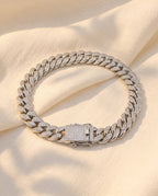 Marco Maveri Cuban Link Bracelet with Cubic Zirconia laid on cream linen, Silver