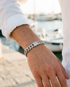 Marco Maveri Cuban Link Bracelet with Cubic Zirconia worn with a linen shirt, close-up, Silver