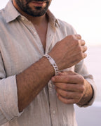 Man adjusting the Marco Maveri Cuban Link Bracelet with Cubic Zirconia, close-up, Silver