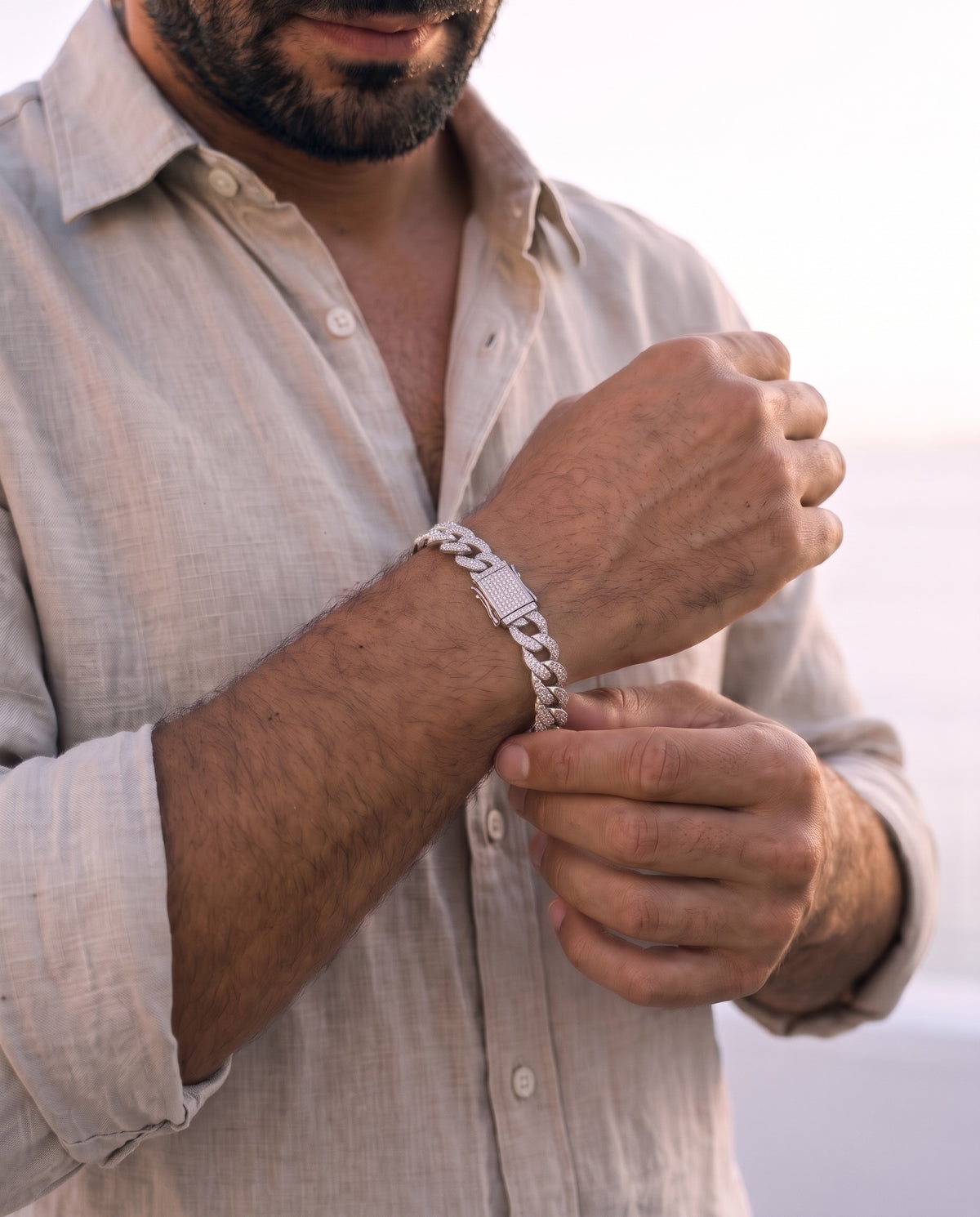 Man adjusting the Marco Maveri Cuban Link Bracelet with Cubic Zirconia, close-up, Silver