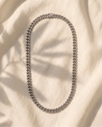 Marco Maveri Silver Cuban Link Chain laid on cream linen, Silver