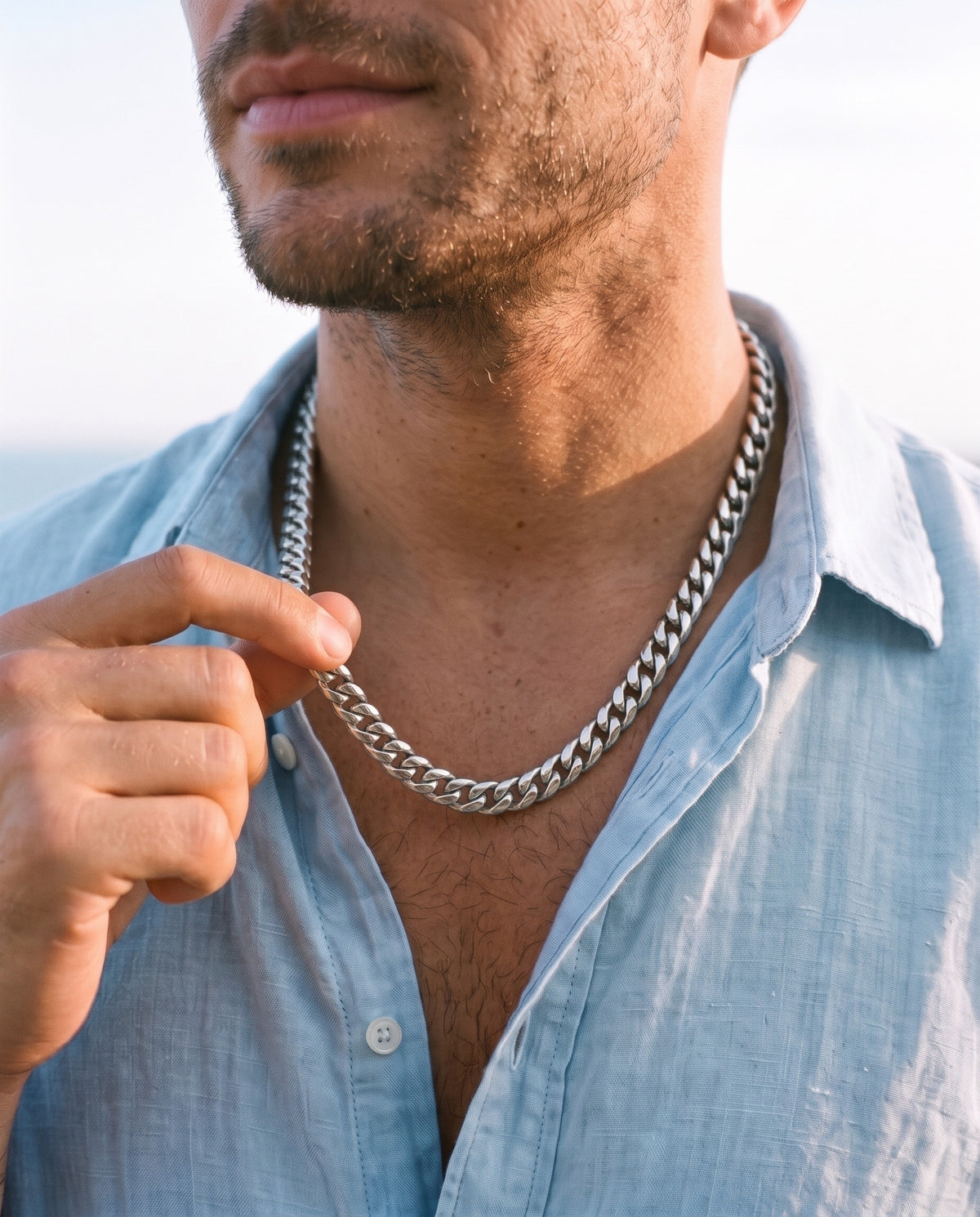 Man adjusting the Marco Maveri Silver Cuban Link Chain, close-up, Silver