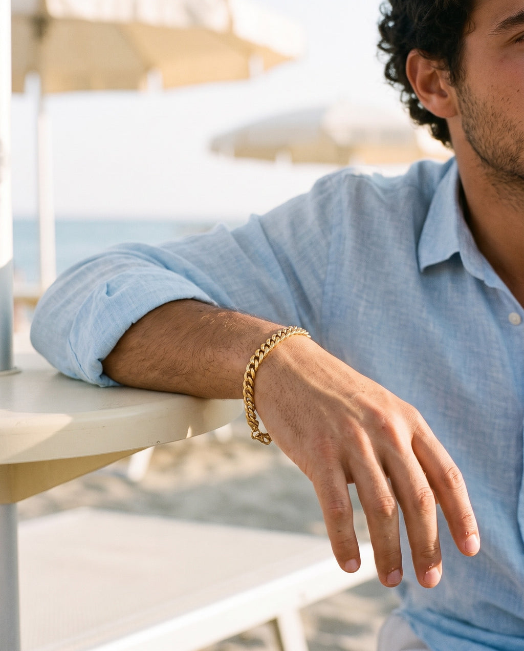 Marco Maveri Cuban Link Chain Bracelet worn with a linen shirt, close-up, Gold