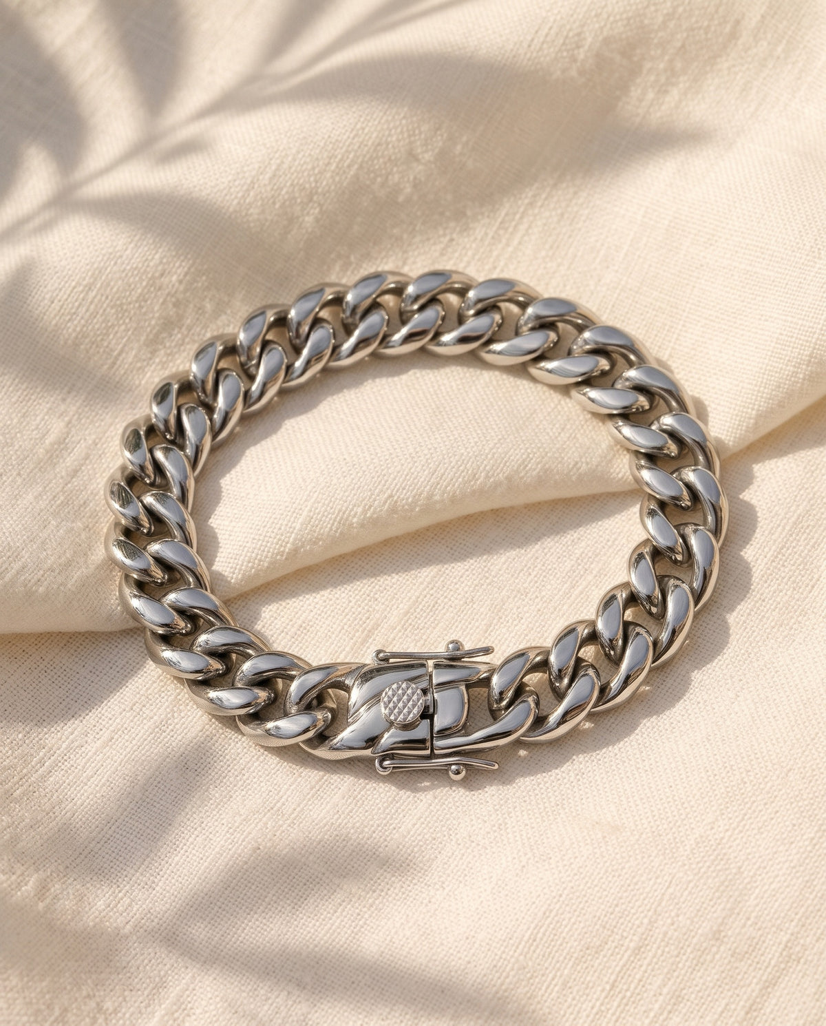 Marco Maveri Cuban Link Chain Bracelet with Box Clasp laid on cream linen, Silver