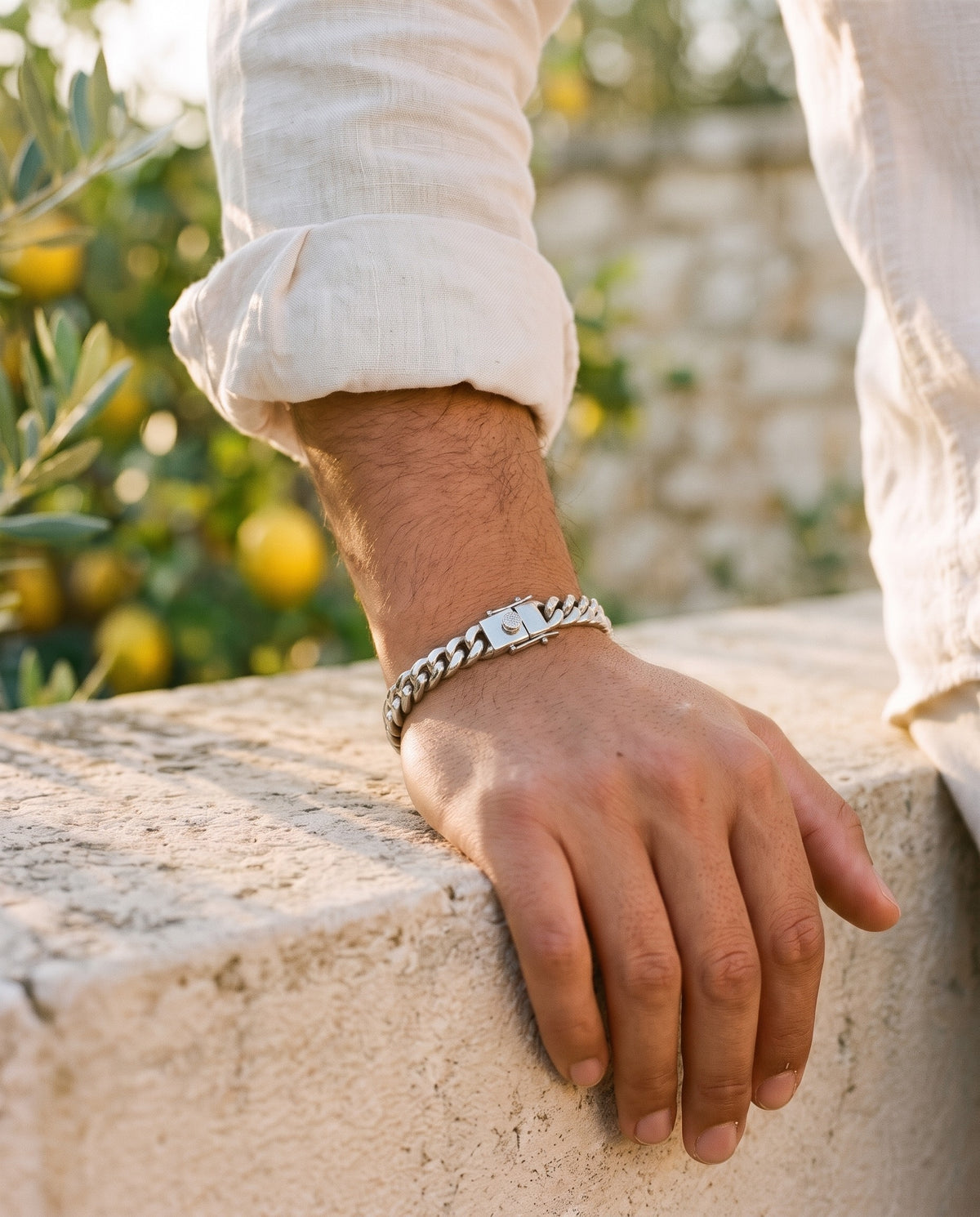 Marco Maveri Cuban Link Chain Bracelet with Box Clasp worn with a linen shirt, close-up, Silver