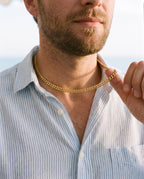 Man adjusting the Marco Maveri Cuban Link Chain Necklace, close-up, Gold