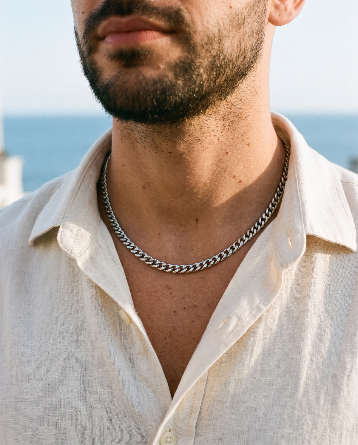 Marco Maveri Cuban Link Chain Necklace worn with a linen shirt, close-up, Silver