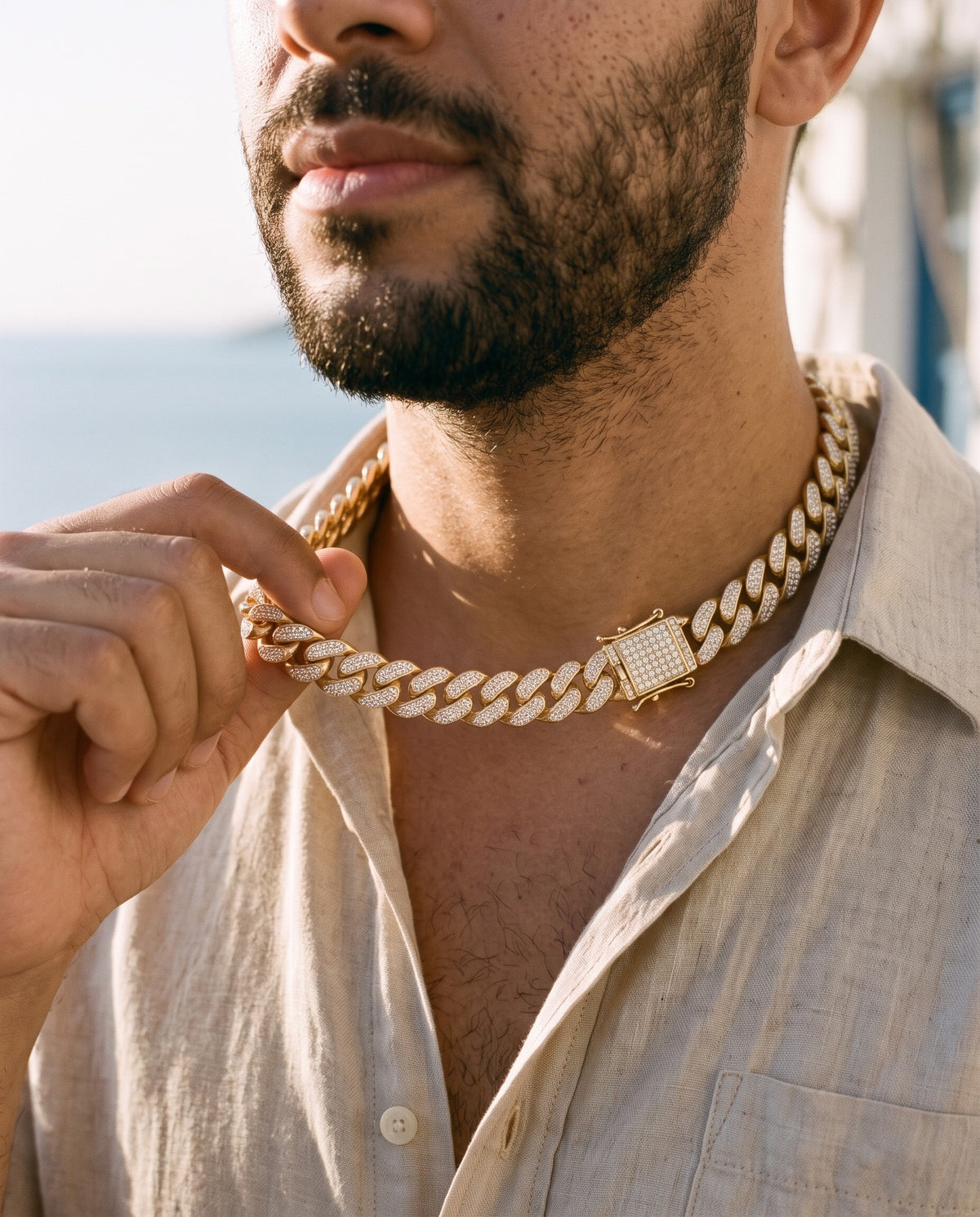 Man adjusting the Marco Maveri Cuban Link Chain with Cubic Zirconia, close-up, Gold