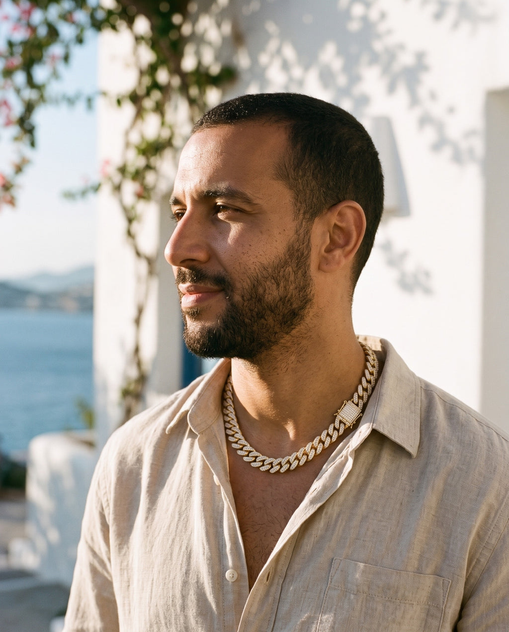 Man wearing the Marco Maveri Cuban Link Chain with Cubic Zirconia by the sea, Gold