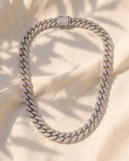 Marco Maveri Cuban Link Chain with Cubic Zirconia laid on cream linen, Silver
