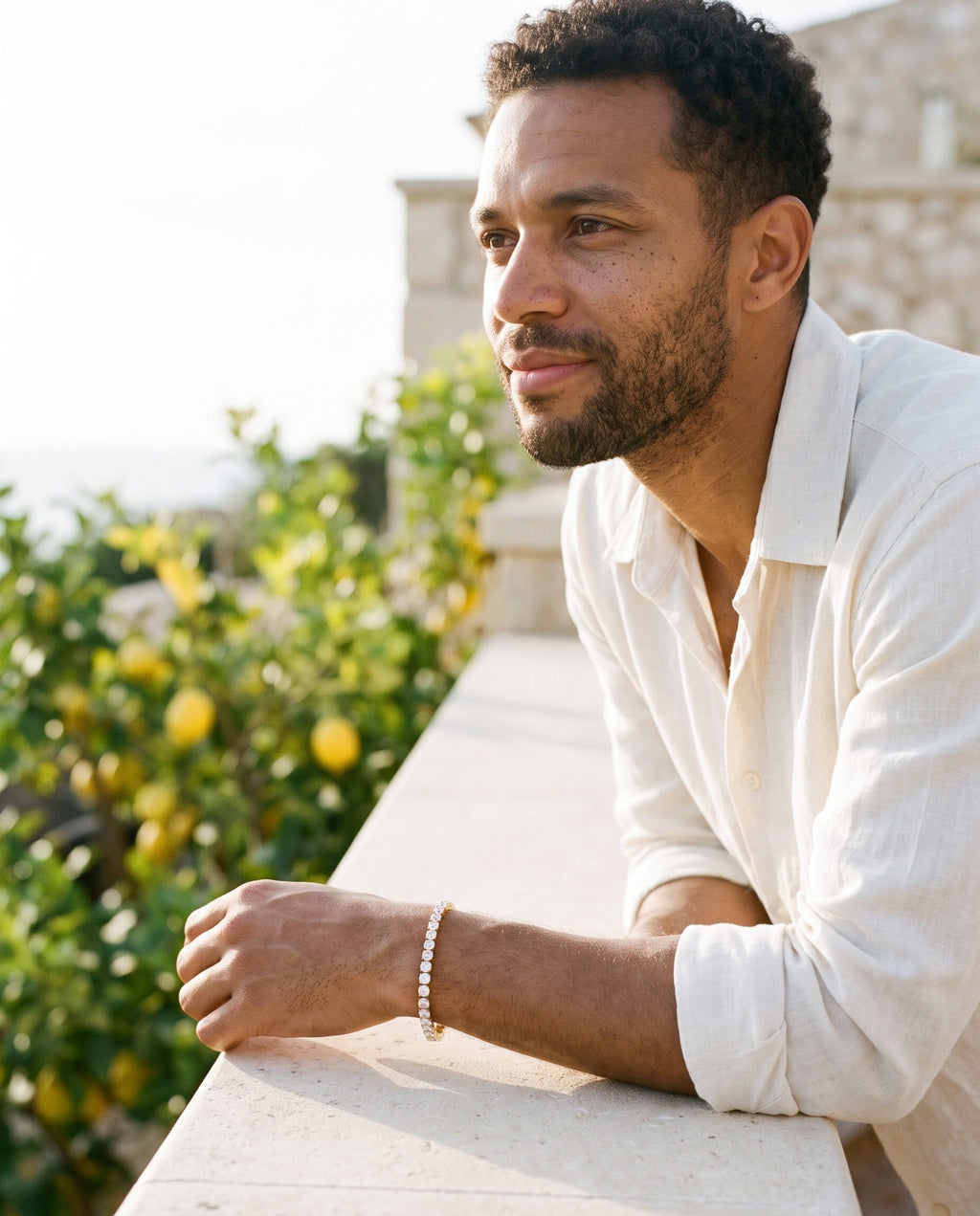 Man wearing the Marco Maveri Cubic Zirconia Tennis Bracelet by the sea, Gold