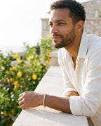 Man wearing the Marco Maveri Cubic Zirconia Tennis Bracelet by the sea, Gold