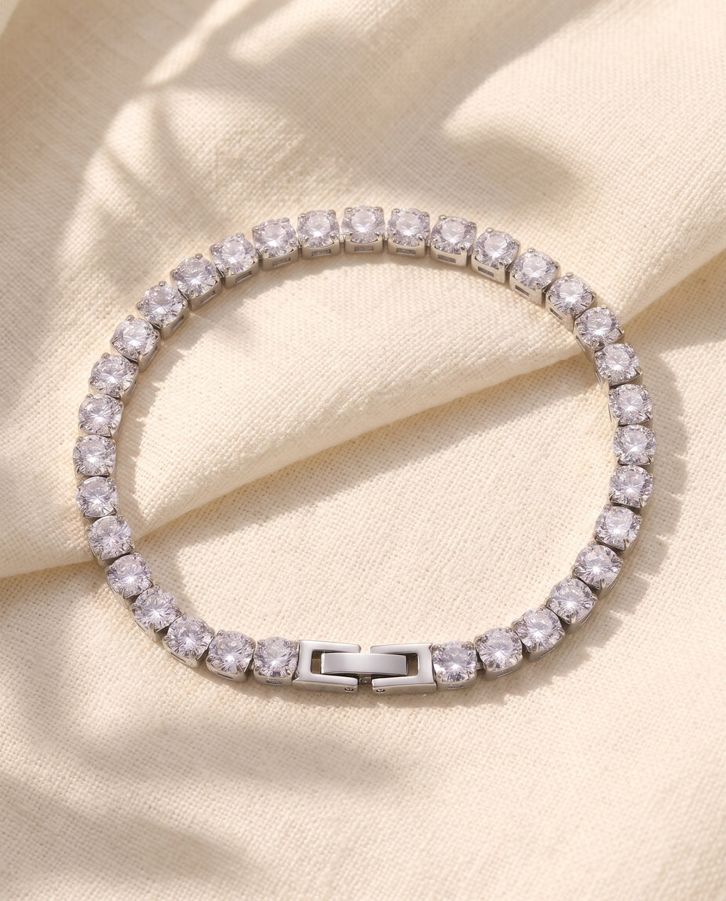 Marco Maveri Cubic Zirconia Tennis Bracelet laid on cream linen, Silver