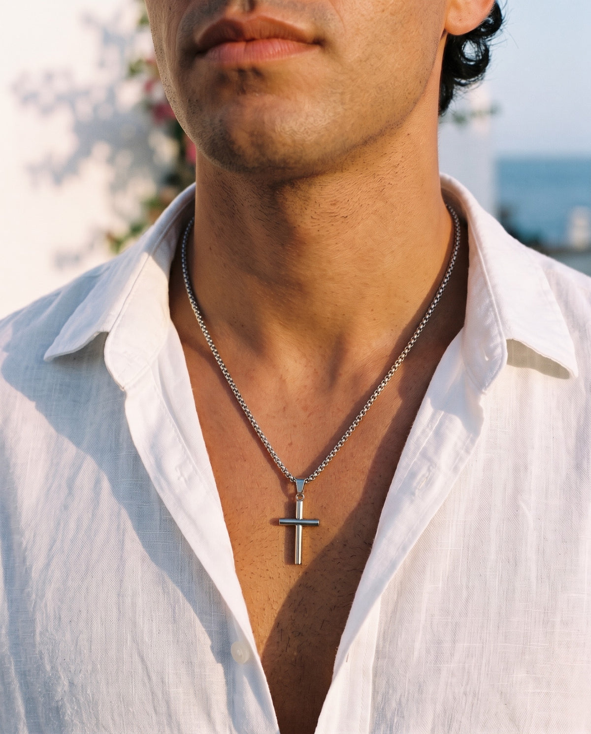 Marco Maveri Cylindrical Cross Pendant Necklace worn with a linen shirt, close-up, Silver