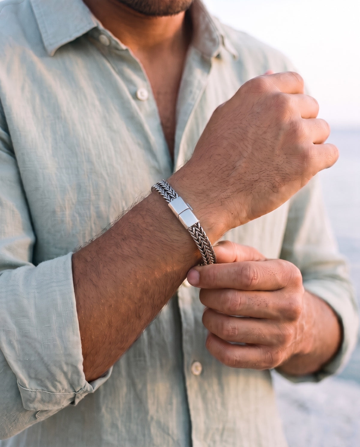 Man adjusting the Marco Maveri Double Wheat Link Bracelet, close-up, Silver