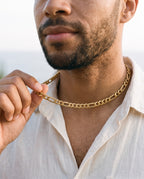 Man adjusting the Marco Maveri Figaro Chain Necklace in Stainless Steel, close-up, Gold