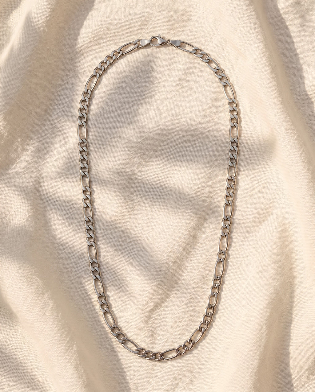 Marco Maveri Figaro Chain Necklace in Stainless Steel laid on cream linen, Silver
