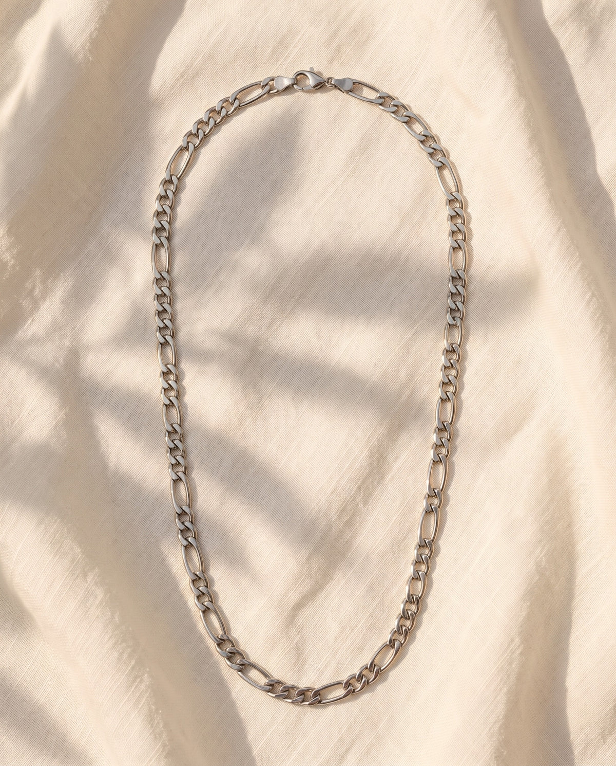Marco Maveri Figaro Chain Necklace in Stainless Steel laid on cream linen, Silver