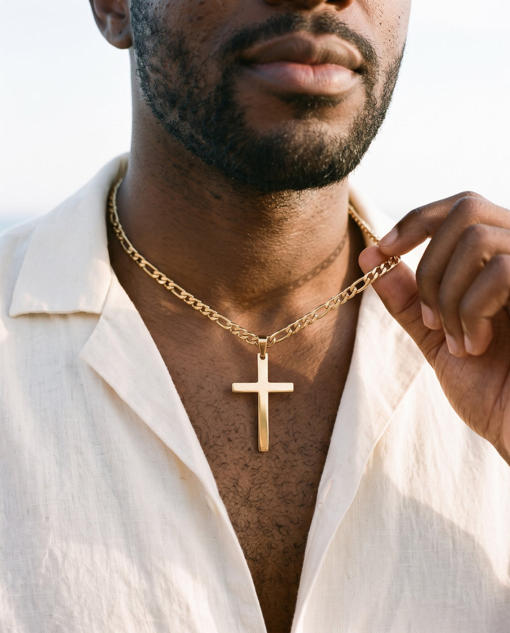 Man adjusting the Marco Maveri Figaro Chain with Cross Pendant, close-up, Gold