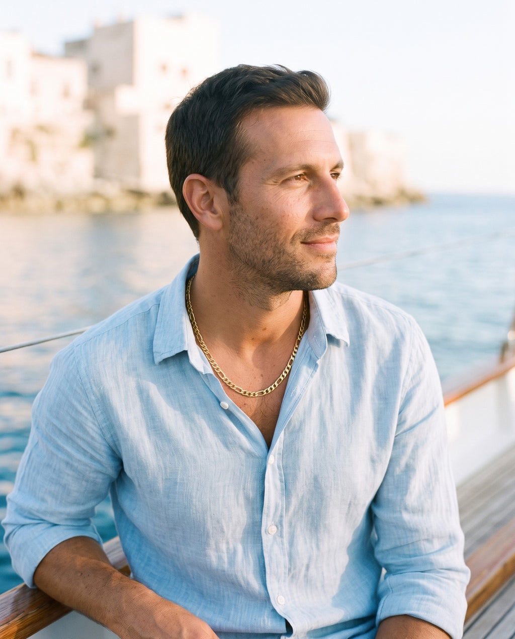 Man wearing the Marco Maveri Figaro Link Chain Necklace by the sea, Gold