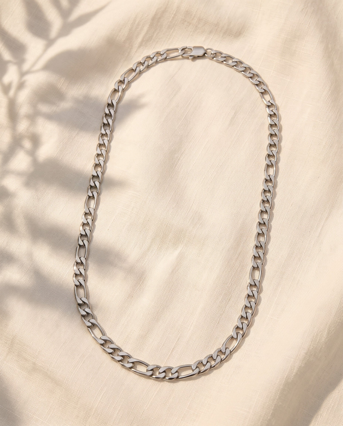 Marco Maveri Figaro Link Chain Necklace laid on cream linen, Silver
