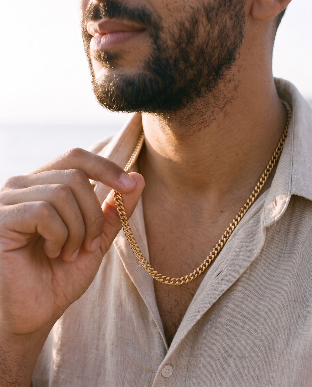 Man adjusting the Marco Maveri Franco Link Chain Necklace, close-up, Gold